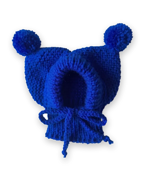 Blue knitted dog hood with two pom-poms