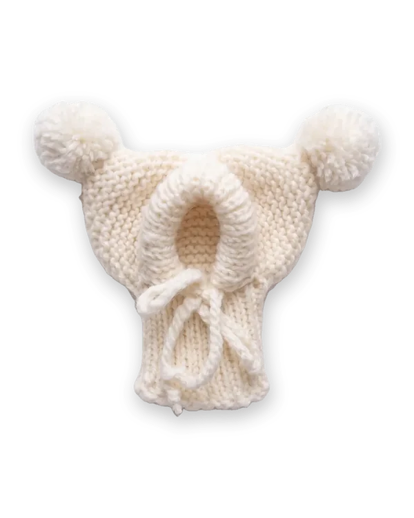 White knitted dog hood with two pom-poms